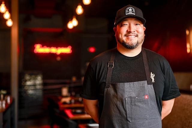 Chef Kevin Lee smiling in his restaurant